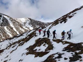Group of hikers trekking through volcanic terrain